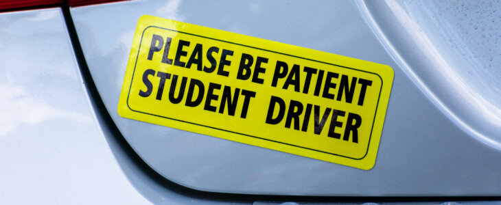 Please Be Patient Student Driver - yellow bumper sticker on the car